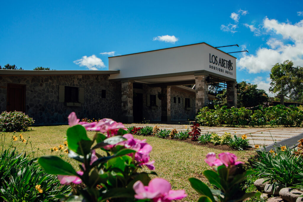 Main facade of Los Abetos Boutique Hotel in Boquete, a boutique hotel surrounded by nature with an elegant and cozy design.